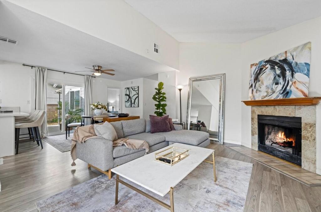 a living room with a couch and a fireplace at Modern Private 3B-2BA Home and Spacious Yard in Lancaster