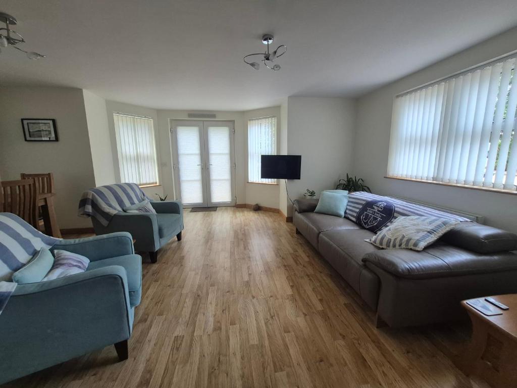 a living room with two couches and a tv at Bobbi's Bothy in Newcastle