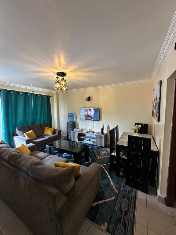 a living room with a couch and a table at Vane luxury Homes in Kisii