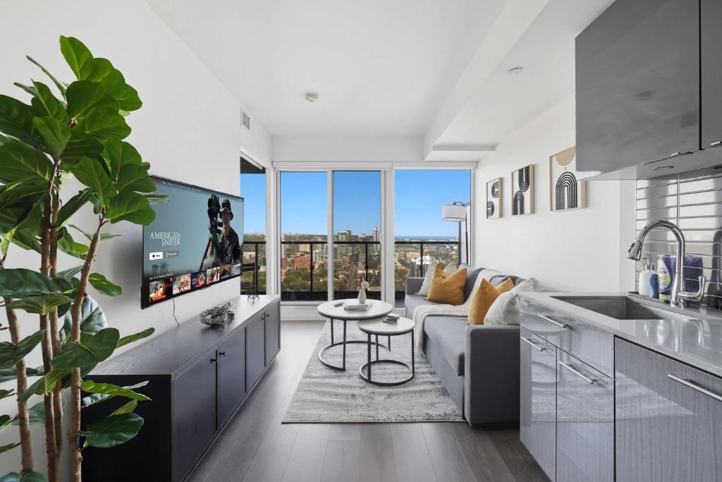 a kitchen and living room with a couch and a table at Bright 2BR Downtown Toronto Condo in Toronto