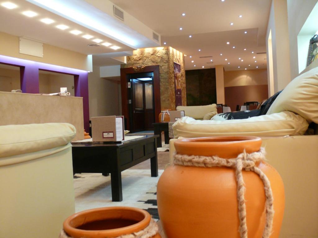 a room with couches and a vase with a rope at Gregorio I Hotel Boutique in San Salvador de Jujuy