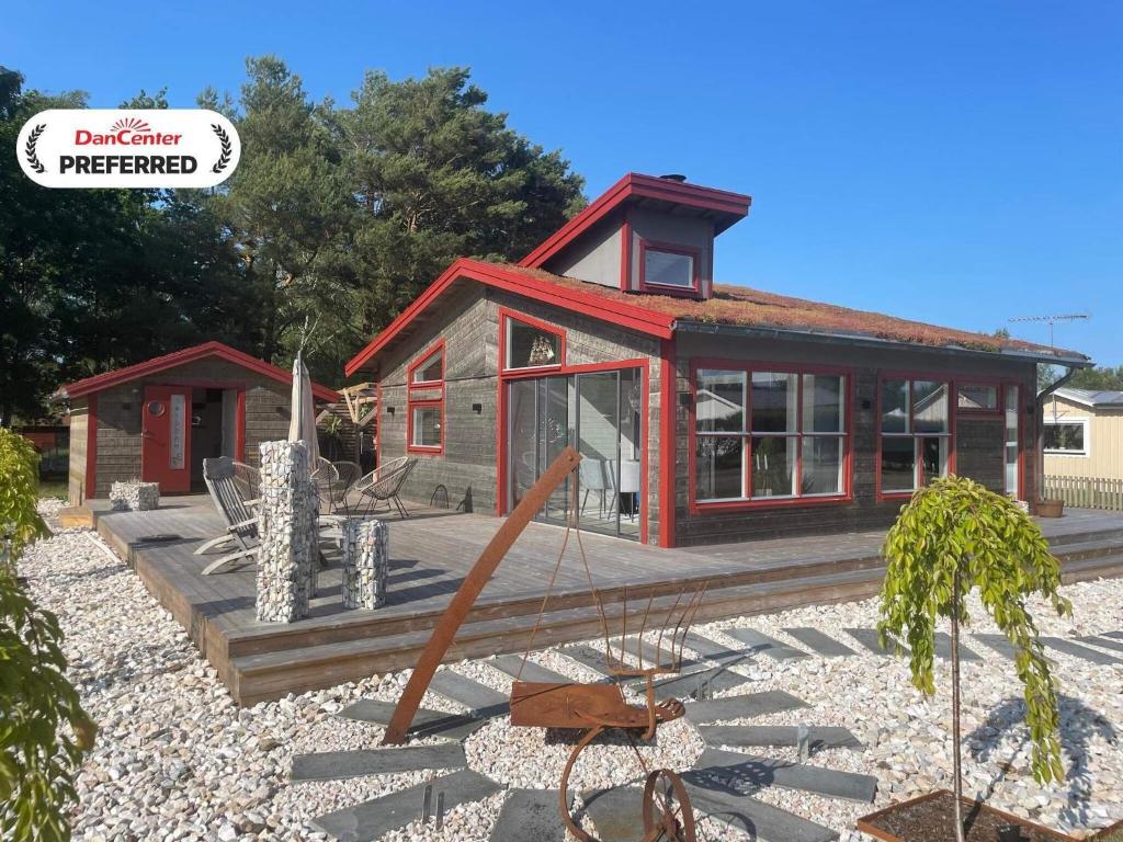 a small house with a red roof at 5 star holiday home in Skummeslövsstrand in Skummeslövsstrand