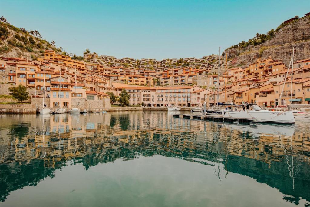 a view of a city with boats in the water at Tivoli Portopiccolo Sistiana Wellness Resort & Spa in Sistiana