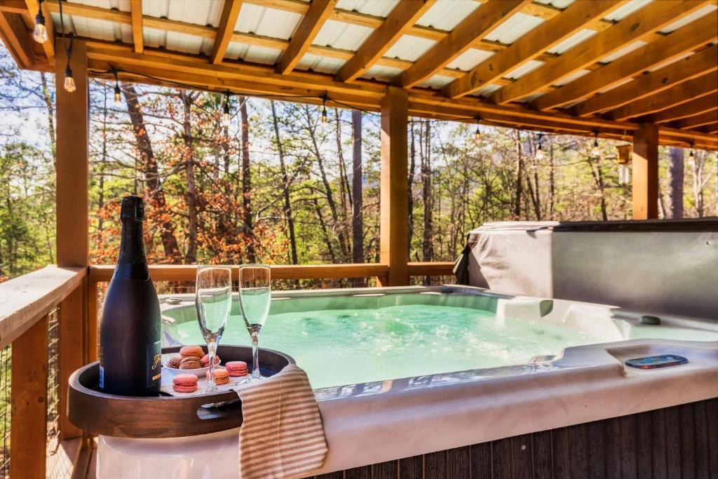 a hot tub on a deck with glasses of wine at 3 Bed2 King4 Singlegame Rmhot Tbdog Friendly in Waldens Creek