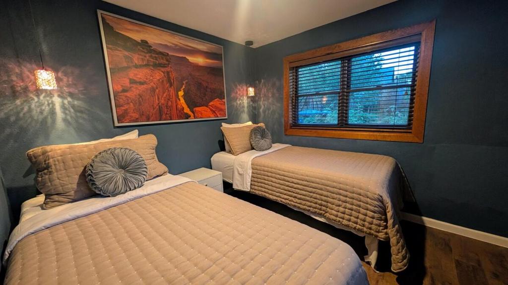 a bedroom with two beds and a window at Hot Tub, 3 Bedrooms 2 Baths, Walk to Everything! in Flagstaff