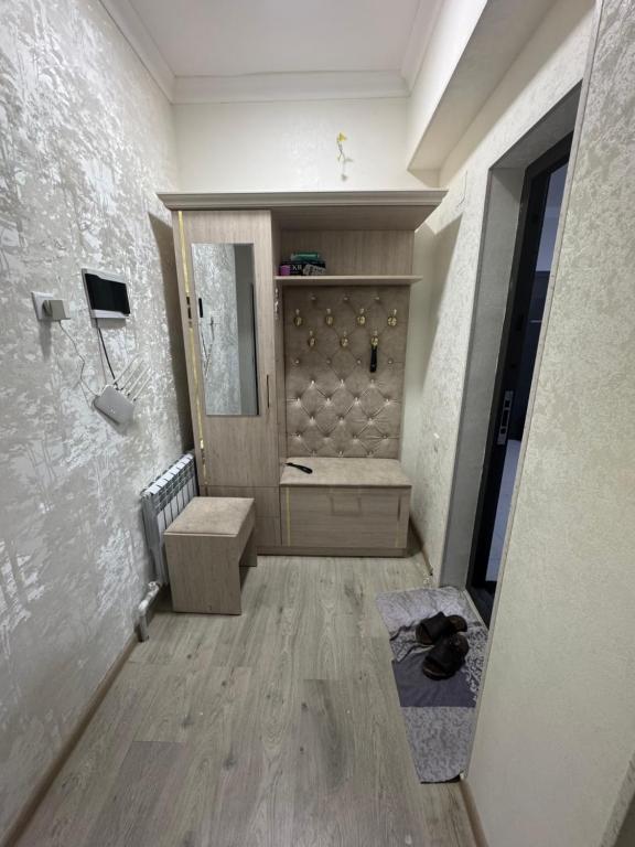 a bathroom with a bench and a sink in a room at Xakan City in Andijan