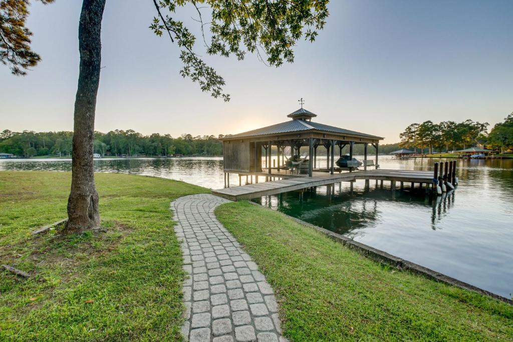 a gazebo on the water next to a lake at Waterfront Escape with Hot tub and Dock in Eatonton! in Resseaus Crossroads