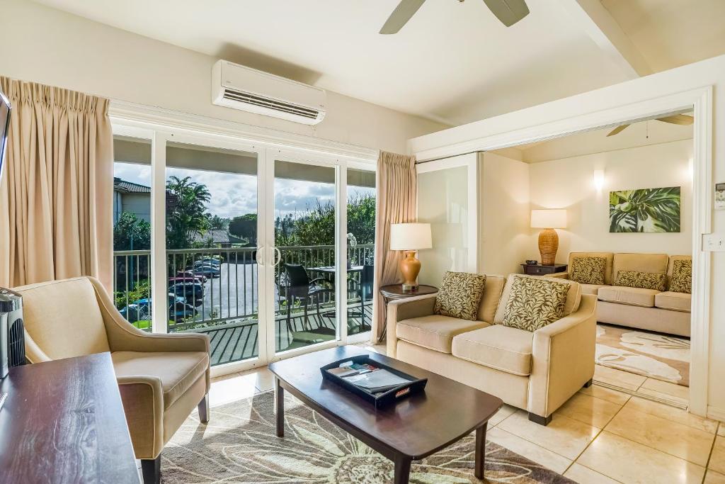 a living room with a couch and a table at Kauai Kailani 319 in Waipouli