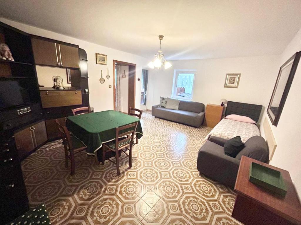 a living room with a couch and a table at Casa Checolongo in Ziano di Fiemme