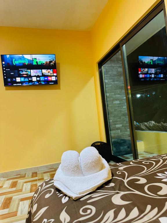 a room with a bed with two towels on it at Hospedaje chachalacas in Chachalacas