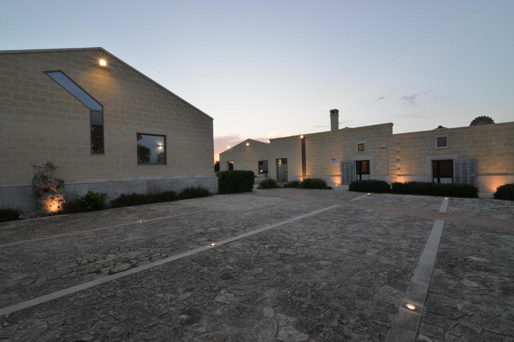 an empty parking lot in front of two buildings at Masseria La Meridiana in Altamura
