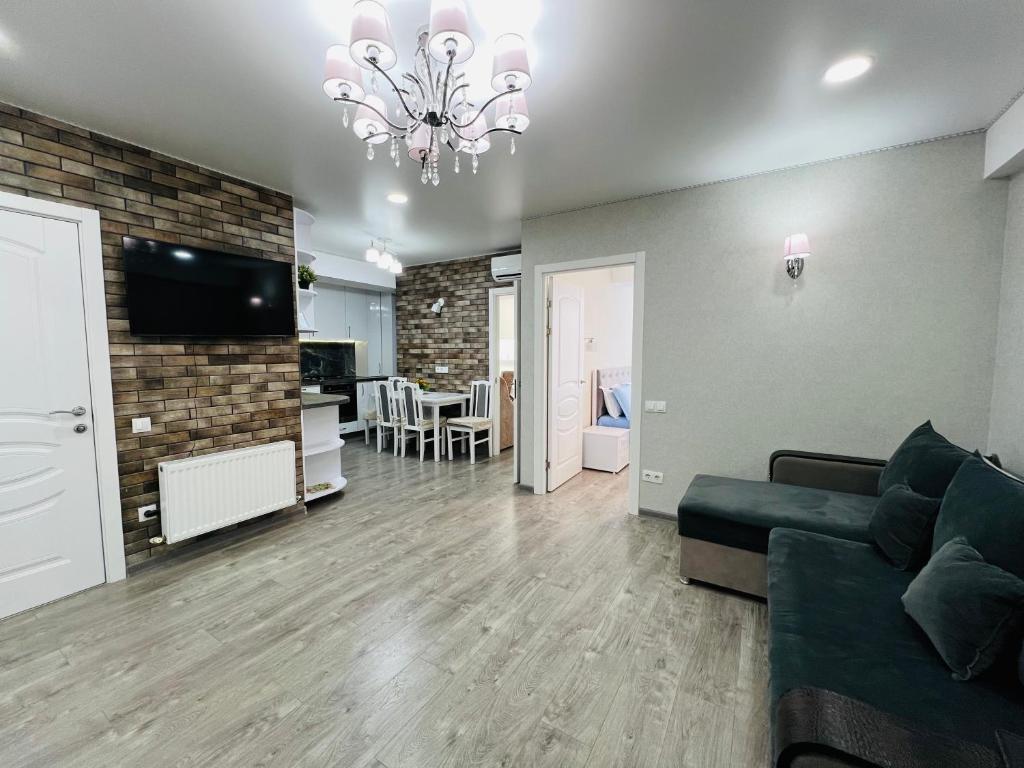 a living room with a couch and a dining room at Chișinău MallDova in Chişinău