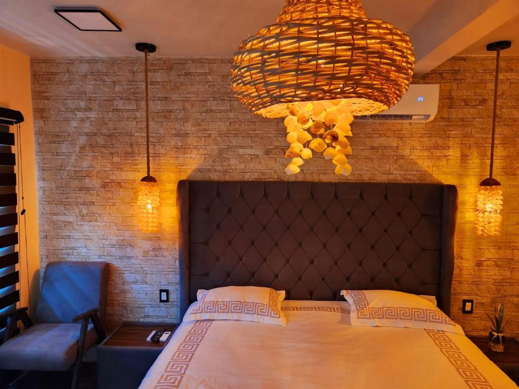 a bedroom with a large bed and a chandelier at Villas Mar Arena in Isla Aguada