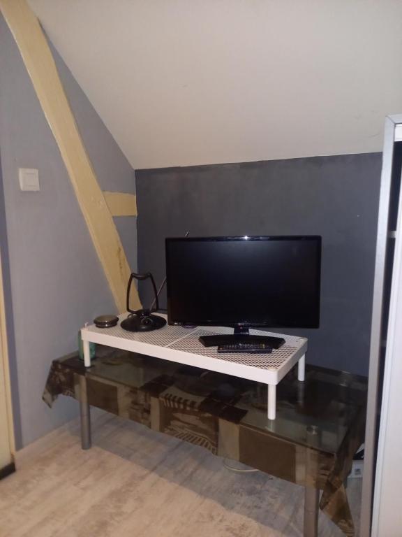 a computer monitor on a table in a room at Loue chambre in Le Mans