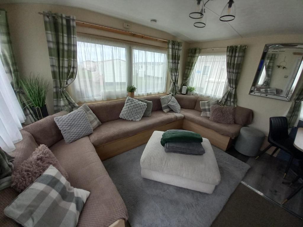 a living room with a couch and a table at SANDY BAY STAYOVER in North Seaton