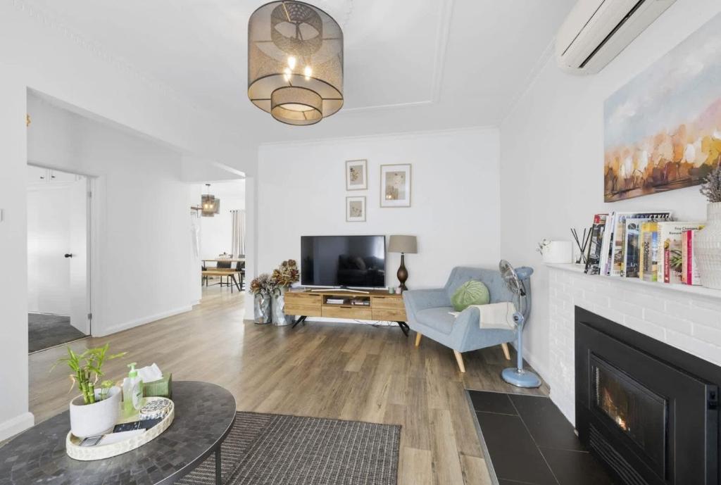 a living room with a fireplace and a tv at Eureka We struck a golden home in Eureka