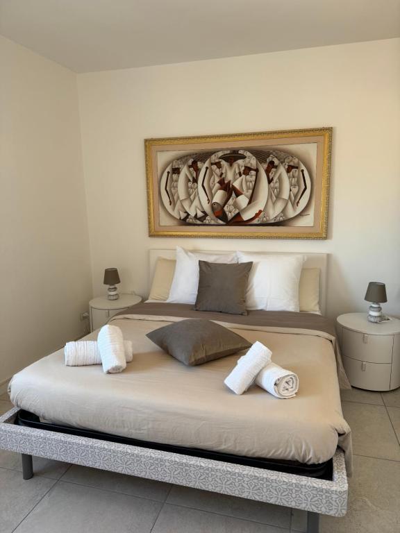 a bedroom with a large bed with towels on it at Il Mirto di Maria- La Terrazza in Fiumicino