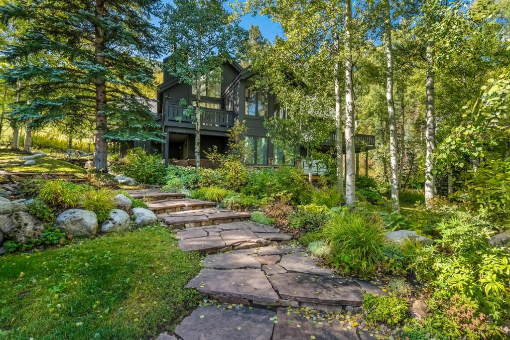 a house with a walkway in the yard at Evergreen Escape - Home for 12 in Mid Vail