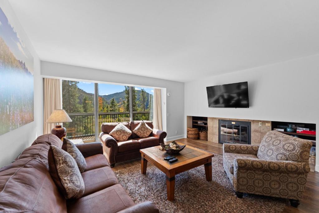 a living room with couches and a tv and a table at Saints John 2520 by Summit County Mountain Retreats in Snake River Health Services Incorporated Heliport