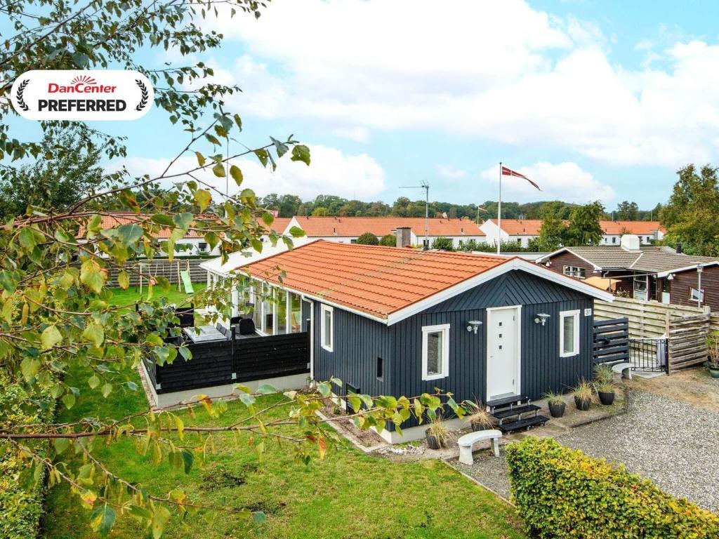 a small house with an orange roof at 7 person holiday home in Juelsminde-By Traum in Juelsminde