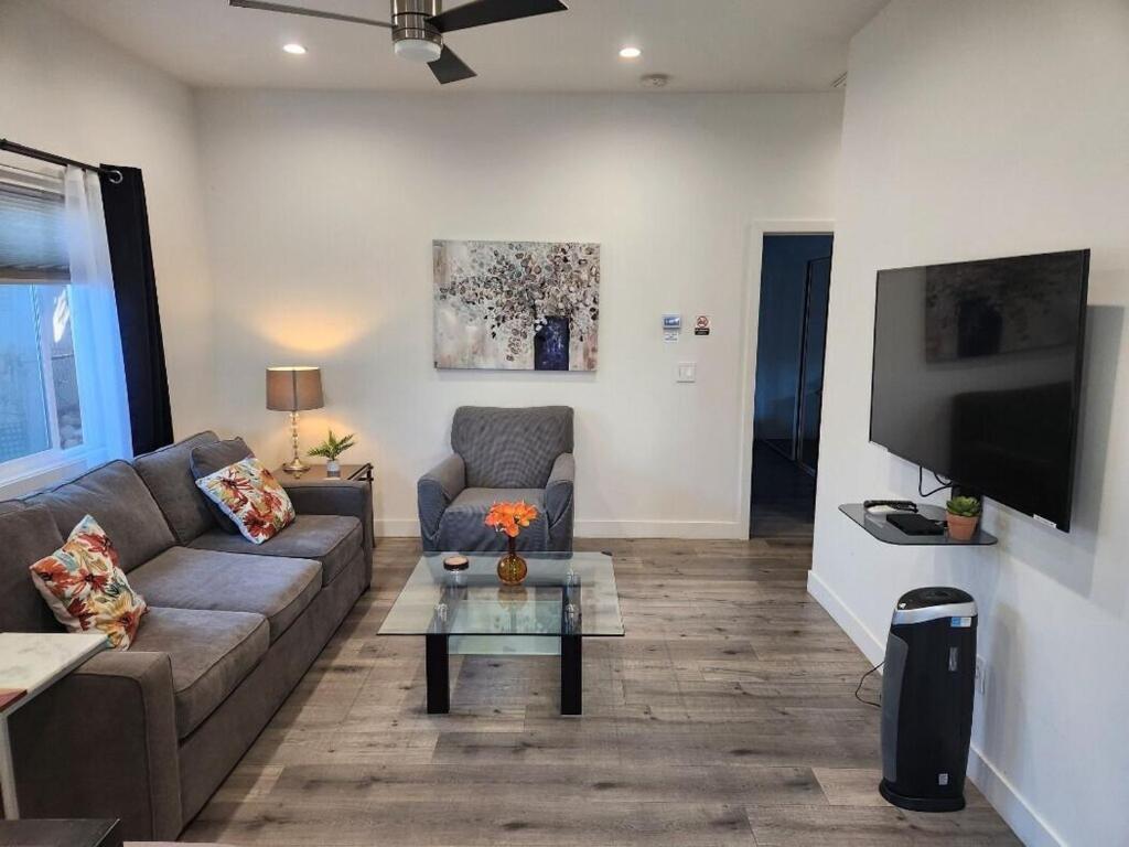 a living room with a couch and a tv at 1Bed 1Full Bath, Full Kitchen, Queen Sofa Bed, Queen Bed, Parking, EV in Northridge