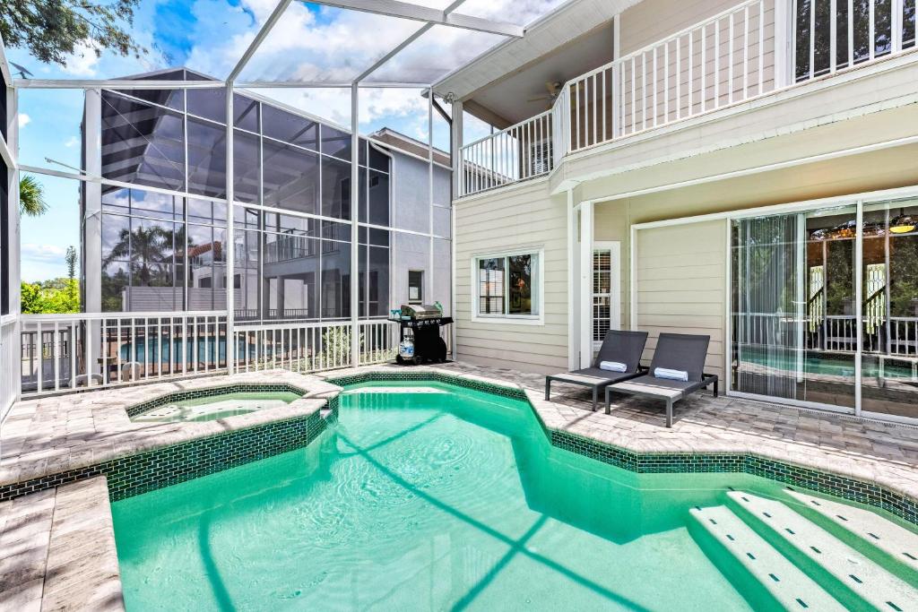 a swimming pool in front of a house at Villa Champagne - 5322 in Siesta Key