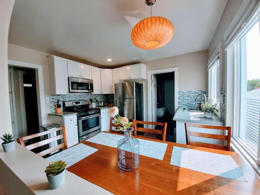 a kitchen with a wooden table with a vase on it at Heart of San Diego-Walk Score 82-Backyard -BBQ-HBO in San Diego