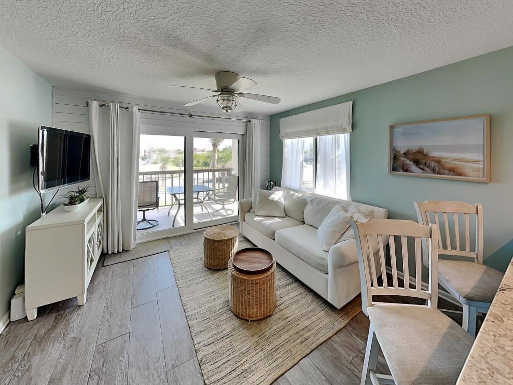 a living room with a couch and a television at Ocean Village Club D23 in Saint Augustine