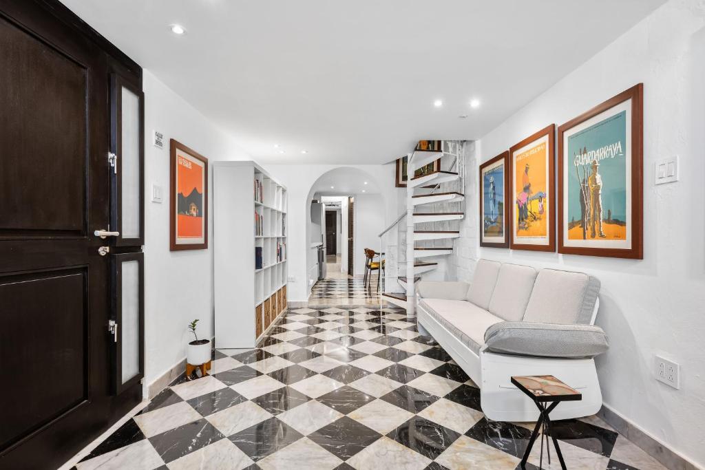 a living room with a couch and a checkered floor at Old San Juan Art Loft Fast Wifi Near El Morro in San Juan