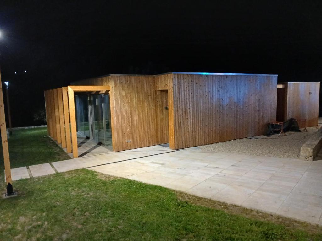 a house being built with wooden walls at night at Casinha Ponte Nova in Monção
