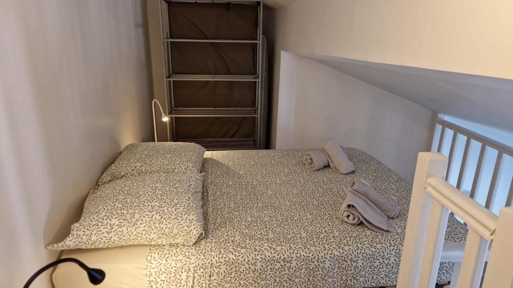 a small bedroom with a bed and a book shelf at Duplex Mezzanine au calme Place de l'Horloge in Avignon