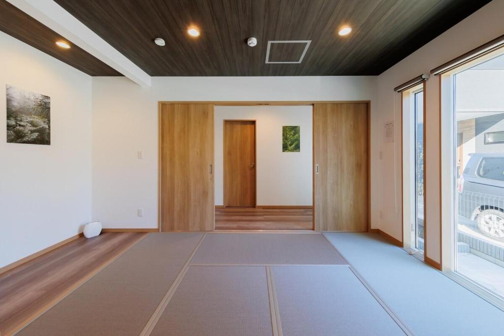 an empty room with a door and a window at The Rabbit 兎a newly built vacation home in Inzai