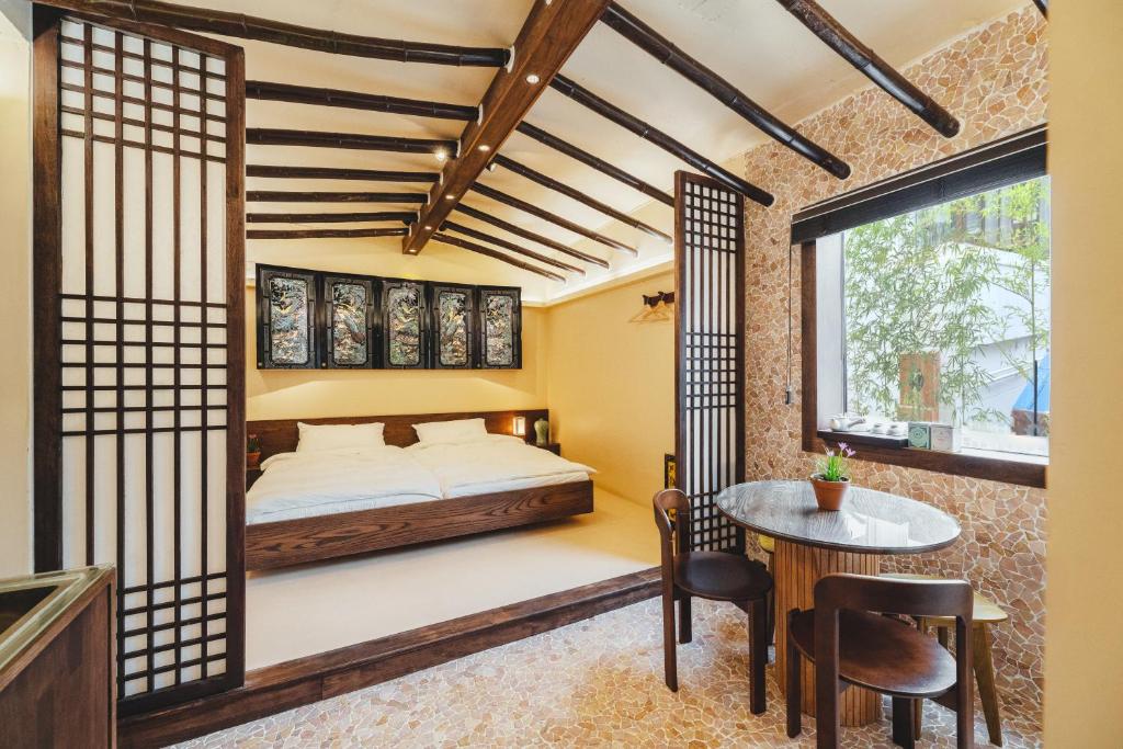 a bedroom with a bed and a table and chairs at Korea's beauty in haeundae with Hinoki wooden bath in Busan