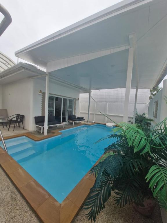 a large blue swimming pool in a house at Superb 3 Bed Pool Villa in Ban Saiyuan (1)