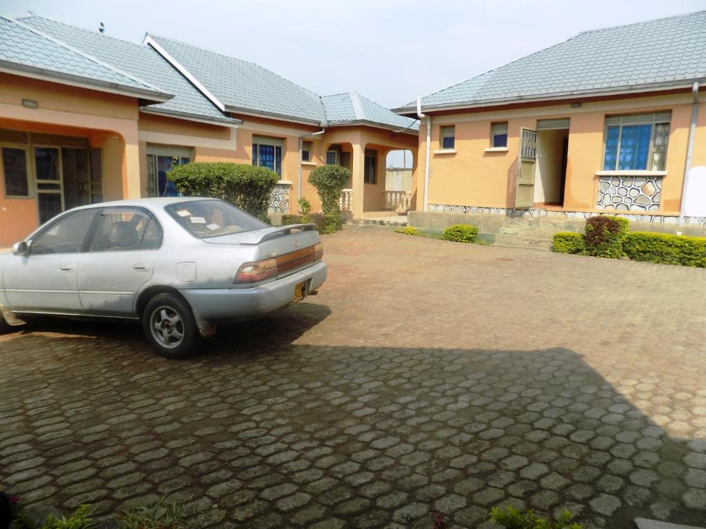a silver car parked in front of a house at Hotel Atlantica in Fort Portal