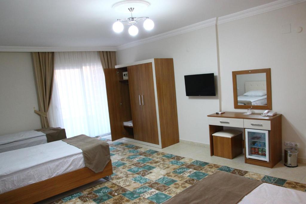 Postel nebo postele na pokoji v ubytování Deveci Hotel