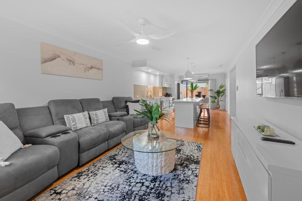a living room with a couch and a table at Hilltop Residences Chermside in Brisbane