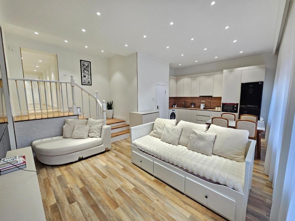 a living room with a bed and a kitchen at Rooftop 1 Bedroom, Near City Center in Ulaanbaatar