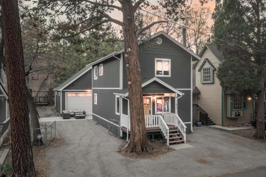 a gray house with a tree in front of it at Peak Pursuit Jacuzzi, Sauna, Game Room, Renovated in Sugarloaf