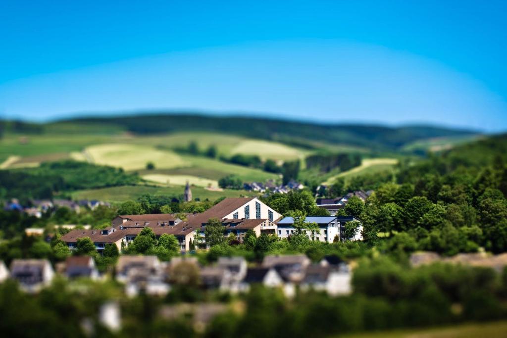 a village in the hills with houses and trees at Bergkloster Bestwig in Bestwig
