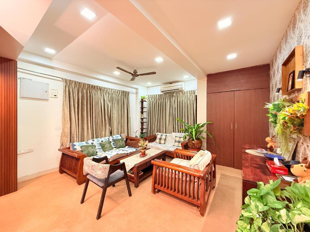 a living room with a couch and a table at Hilltop Hideaway Party Friendly 4BHK Pool Villa by Spacez in Mumbai