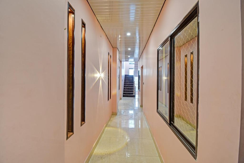 a hallway with paintings on the walls of a building at Hotel O The Honey Guest House in Haldwāni