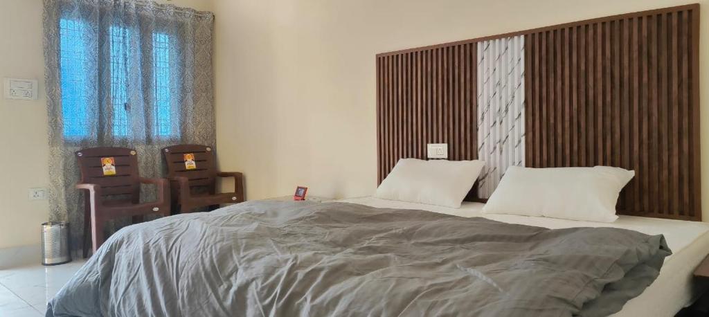 a bedroom with a large bed with two pillows at Valley vibes by Bahugunas den in Srīnagar