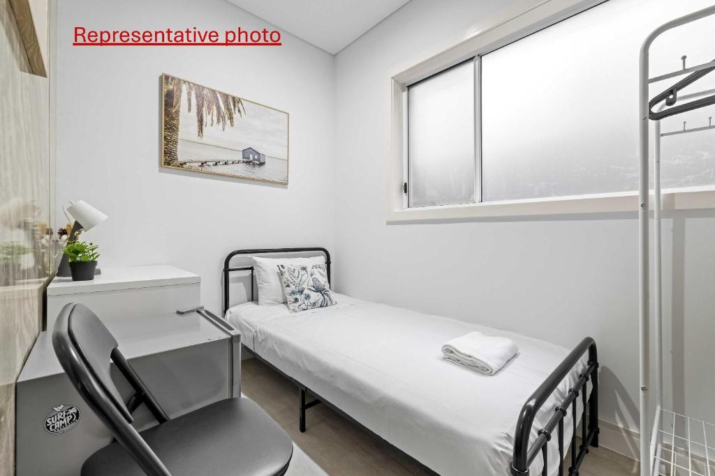 a hospital room with a bed and a chair at Sleek & Comfortable Single Room at Revesby with Shared Amenities in Revesby