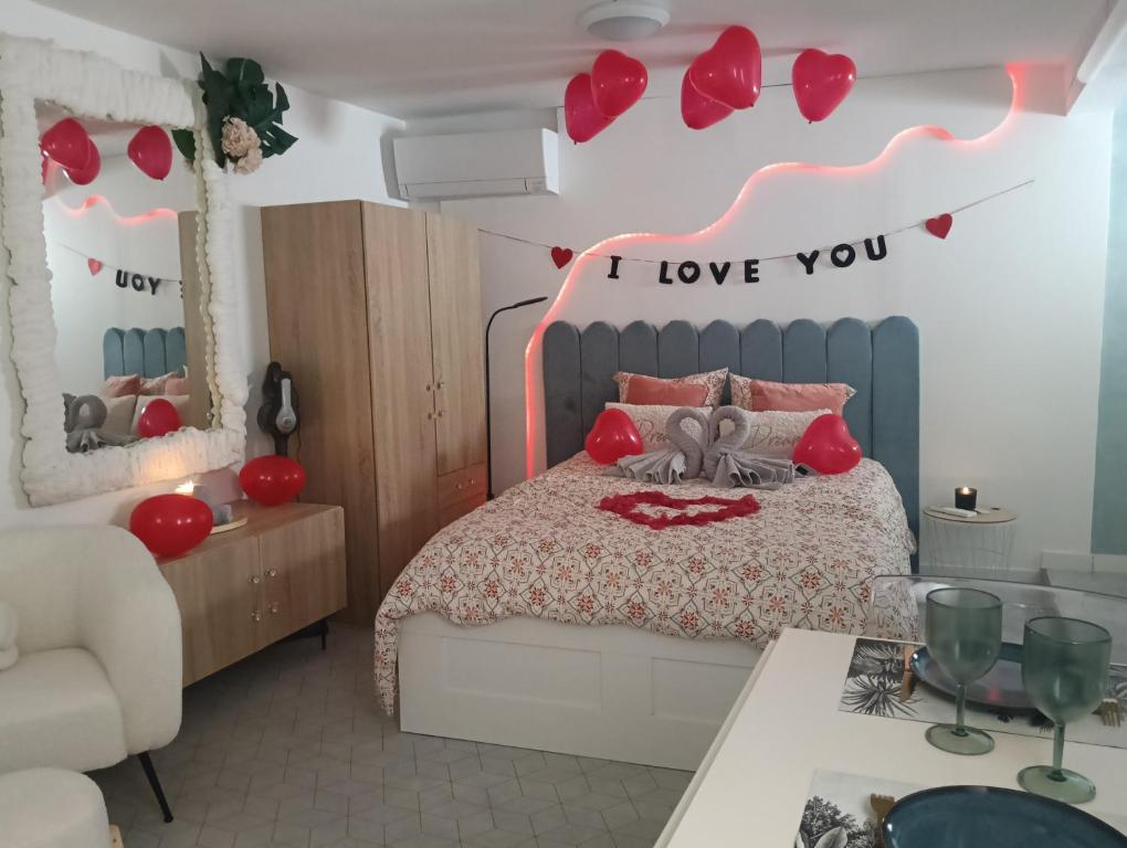 a bedroom with a bed with red hearts on the wall at MARTIGUES Adorable petite guest house in Martigues