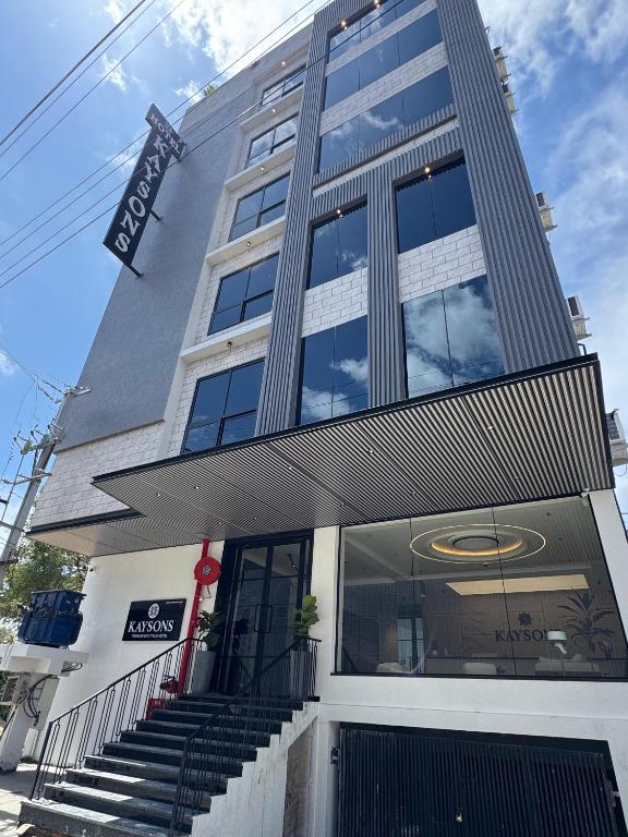 a tall building with stairs in front of it at Kaysons hotel in Hyderabad