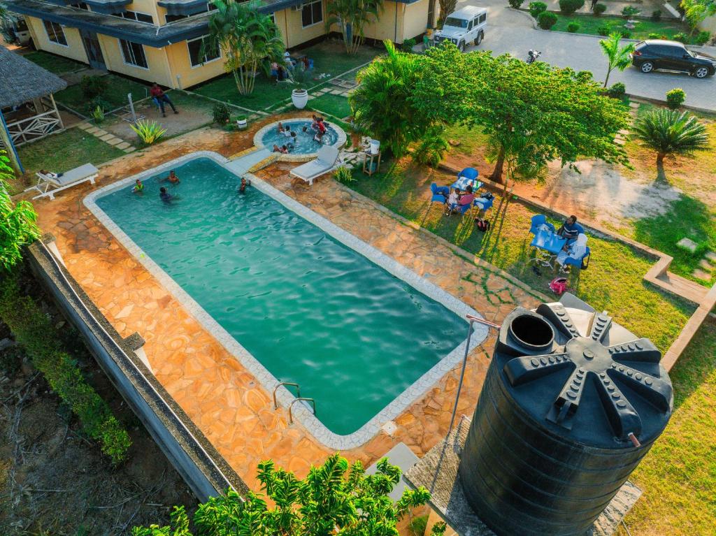 an overhead view of a swimming pool with a waterwheel at Cashewnut Hotel in Mtwara