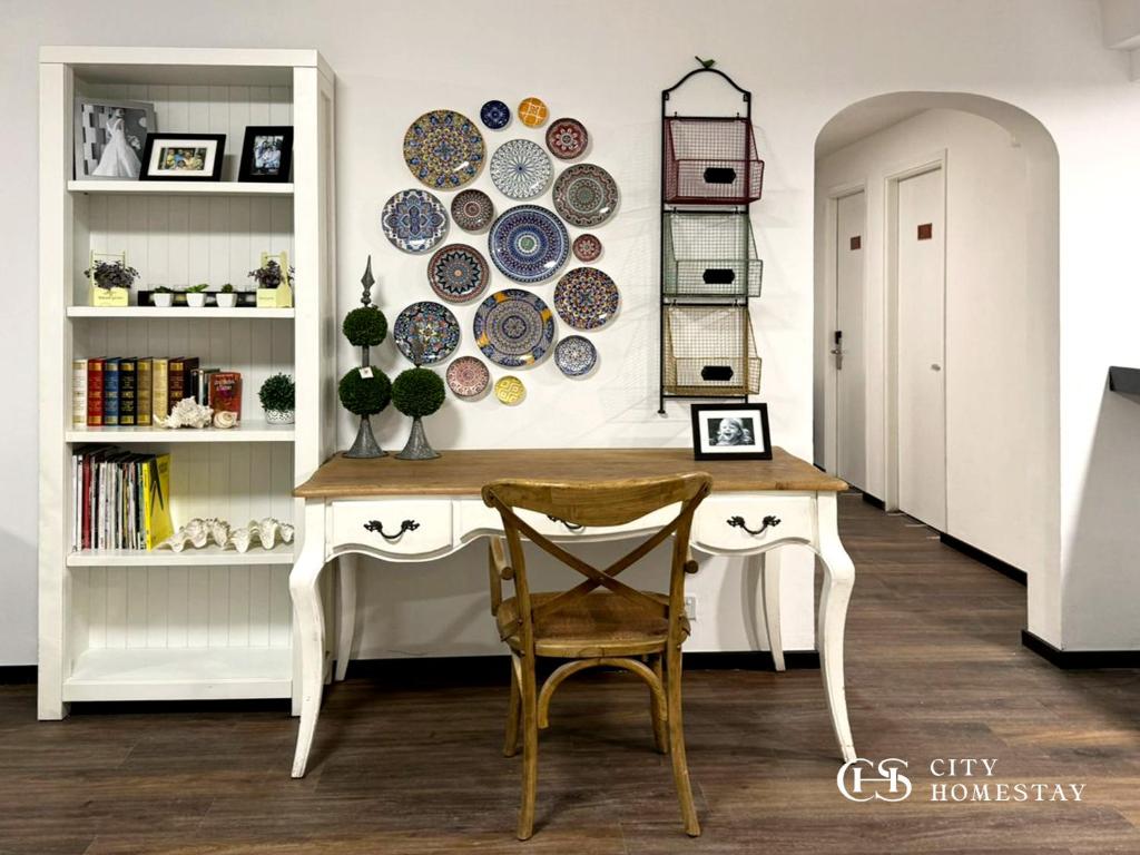 a dining room with a table and plates on the wall at City Homestay in Miri
