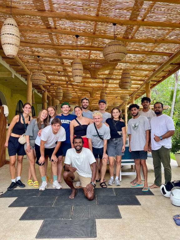 a group of people posing for a picture under awning at Roaming Retreat Ahangama in Ahangama