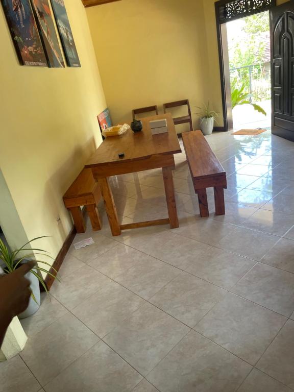 a wooden table and bench in a living room at Ryo hostel in Ahangama